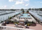 Thumbnail 8 of 47 - a view of a pool and a marina with boats at The Port at East Beach Apartments and Marina, Norkfolk, 23518