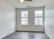 Thumbnail 27 of 47 - an empty living room with three windows and a ceiling fan at The Port at East Beach Apartments and Marina, Norkfolk, 23518