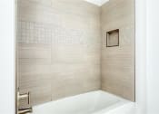 Thumbnail 22 of 47 - a bathroom with a bath tub and a shower at The Port at East Beach Apartments and Marina, Virginia, 23518