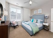 Thumbnail 6 of 32 - a bedroom with a bed and a ceiling fan at Addison Crater Woods, Virginia
