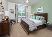 Thumbnail 7 of 32 - a bedroom with a bed and a ceiling fan at Addison Crater Woods, Petersburg