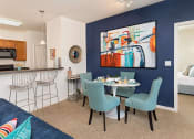 Thumbnail 4 of 32 - a dining area with a table and chairs and a kitchen in the background at Addison Crater Woods, Virginia