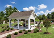 Thumbnail 28 of 32 - a pavilion with picnic tables in a park at Addison Crater Woods, Petersburg