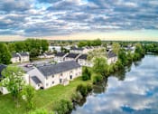 Thumbnail 12 of 21 - an aerial view of a row of houses next to a river