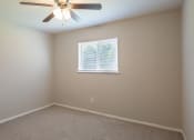 Thumbnail 13 of 16 - a bedroom with a ceiling fan and a window