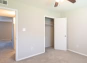 Thumbnail 14 of 16 - a bedroom with a ceiling fan and closet