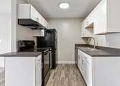 Thumbnail 16 of 43 - a kitchen with white cabinets and black appliances at Village 1373, North Carolina, 27455