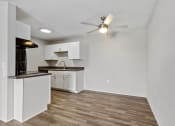 Thumbnail 17 of 43 - an empty living room and kitchen with a ceiling fan at Village 1373, North Carolina