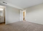Thumbnail 20 of 43 - a spacious living room with carpeting and white walls at Village 1373, Greensboro