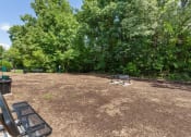 Thumbnail 37 of 43 - a picnic area with a grill and benches in a parkat Village 1373, Greensboro, NC