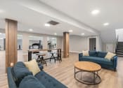 Thumbnail 27 of 43 - a living room with couches and a bar and a staircase   at Village 1373, Greensboro, NC 27455