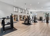 Thumbnail 28 of 43 - a gym with weights and other exercise equipment in a room with windowsat Village 1373, Greensboro North Carolina