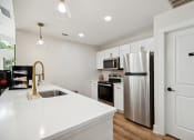 Thumbnail 12 of 44 - a kitchen with white cabinets and stainless steel appliances at Wendover River Oaks, Greensboro, NC, 27409