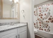 Thumbnail 20 of 44 - a bathroom with a shower and a sink at Wendover River Oaks, Greensboro, NC