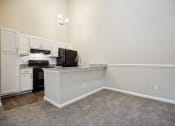 Thumbnail 21 of 44 - a kitchen and dining area in a 555 waverly unit at Wendover River Oaks, Greensboro, NC