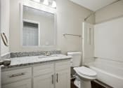Thumbnail 27 of 44 - a bathroom with a bathtub toilet and sink at Wendover River Oaks, Greensboro, NC, 27409