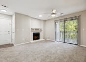 Thumbnail 30 of 44 - a living room with a fireplace and a sliding glass door at Wendover River Oaks, Greensboro, North Carolina
