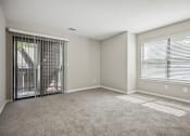 Thumbnail 28 of 44 - a bedroom with two windows and a door leading to a balcony at Wendover River Oaks, Greensboro