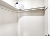 Thumbnail 31 of 52 - a small closet with a white wall and a shelf at Bayville Apartments, Virginia Beach, Virginia