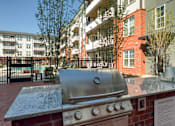 Thumbnail 40 of 40 - A grill is in front of a brick wall with a sign that says "Outdoor Barbecue".