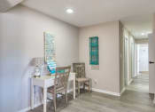 Thumbnail 20 of 52 - a dining room with a table and chairs and a hallway with a door at Bayville Apartments, Virginia Beach