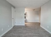 Thumbnail 14 of 18 - A room with a grey floor and white walls.