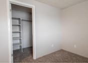Thumbnail 16 of 18 - A white door is open to a room with a shelving unit inside.