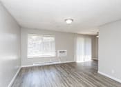 Thumbnail 12 of 16 - A room with a window and a wooden floor.