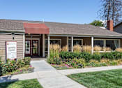 Thumbnail 8 of 16 - The front of a building with a sign that says "Eco-Friendly Leasing Center".