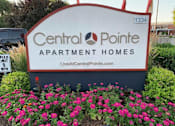 Thumbnail 6 of 16 - A sign for Central Pointe Apartment Homes is surrounded by flowers.