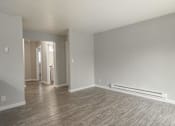 Thumbnail 13 of 13 - A spacious room with wood flooring and white walls.