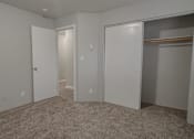 Thumbnail 7 of 13 - A room with a carpeted floor and white walls.
