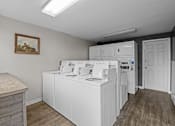 Thumbnail 18 of 18 - A laundry room with a washer and dryer stacked on top of each other.
