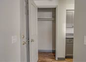 Thumbnail 16 of 18 - A white door with a gold handle is open to a kitchen.