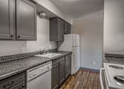 Thumbnail 4 of 18 - A kitchen with a white dishwasher and a white sink.