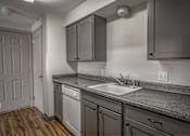 Thumbnail 7 of 18 - A kitchen with a sink and cabinets.