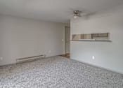 Thumbnail 1 of 18 - Empty room with a ceiling fan and a radiator on the wall.