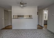 Thumbnail 9 of 18 - A room with a ceiling fan and a white wall.