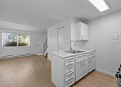 Thumbnail 11 of 15 - A kitchen with white cabinets and a black stove top oven.