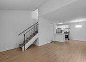 Thumbnail 13 of 15 - A kitchen with a staircase leading to the upper floor.