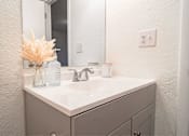Thumbnail 5 of 15 - A white sink with a silver faucet and a mirror above it.