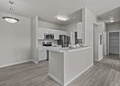 Thumbnail 22 of 25 - A modern kitchen with a white island and stainless steel appliances.