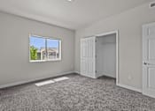 Thumbnail 11 of 25 - A room with a large window and a view of a house outside.