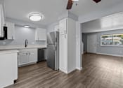 Thumbnail 2 of 34 - A kitchen with white cabinets and a refrigerator.