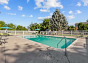 Thumbnail 26 of 34 - A swimming pool surrounded by a fence and trees.