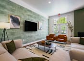 Thumbnail 3 of 61 - A living room with a white couch and a green wall.