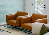 Thumbnail 7 of 61 - Two brown leather chairs and a white couch in a room.