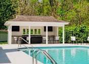 Thumbnail 15 of 61 - A pool with a pavilion in the background.
