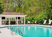 Thumbnail 16 of 61 - A pool with a pavilion in the background.