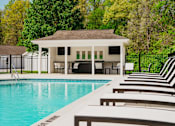 Thumbnail 18 of 61 - A pool with a gazebo in the background.